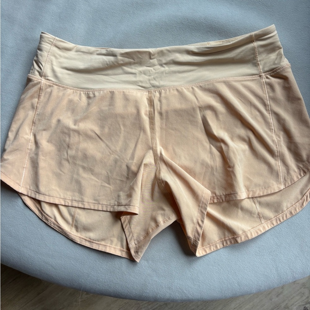 Lululemon size 10 speed up shorts. 4 inch. The color is a peach color.
